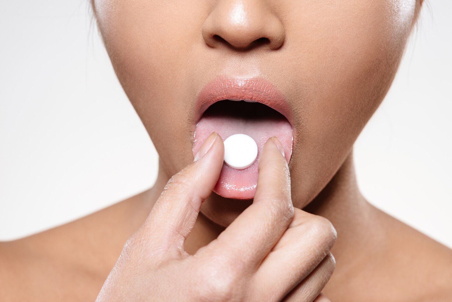 woman-holding-pill-her-mouth_171337-1777